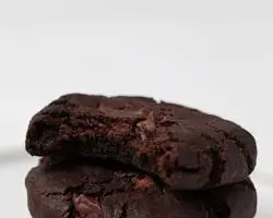 Chewy vegan chocolate chip cookies with crispy edges and melted dark chocolate chunks".